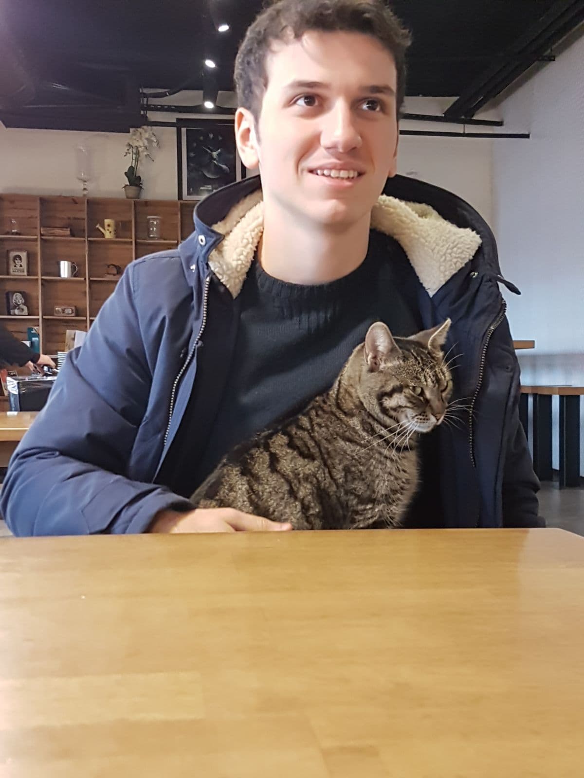 Kubilay during his bachelor years with a cat